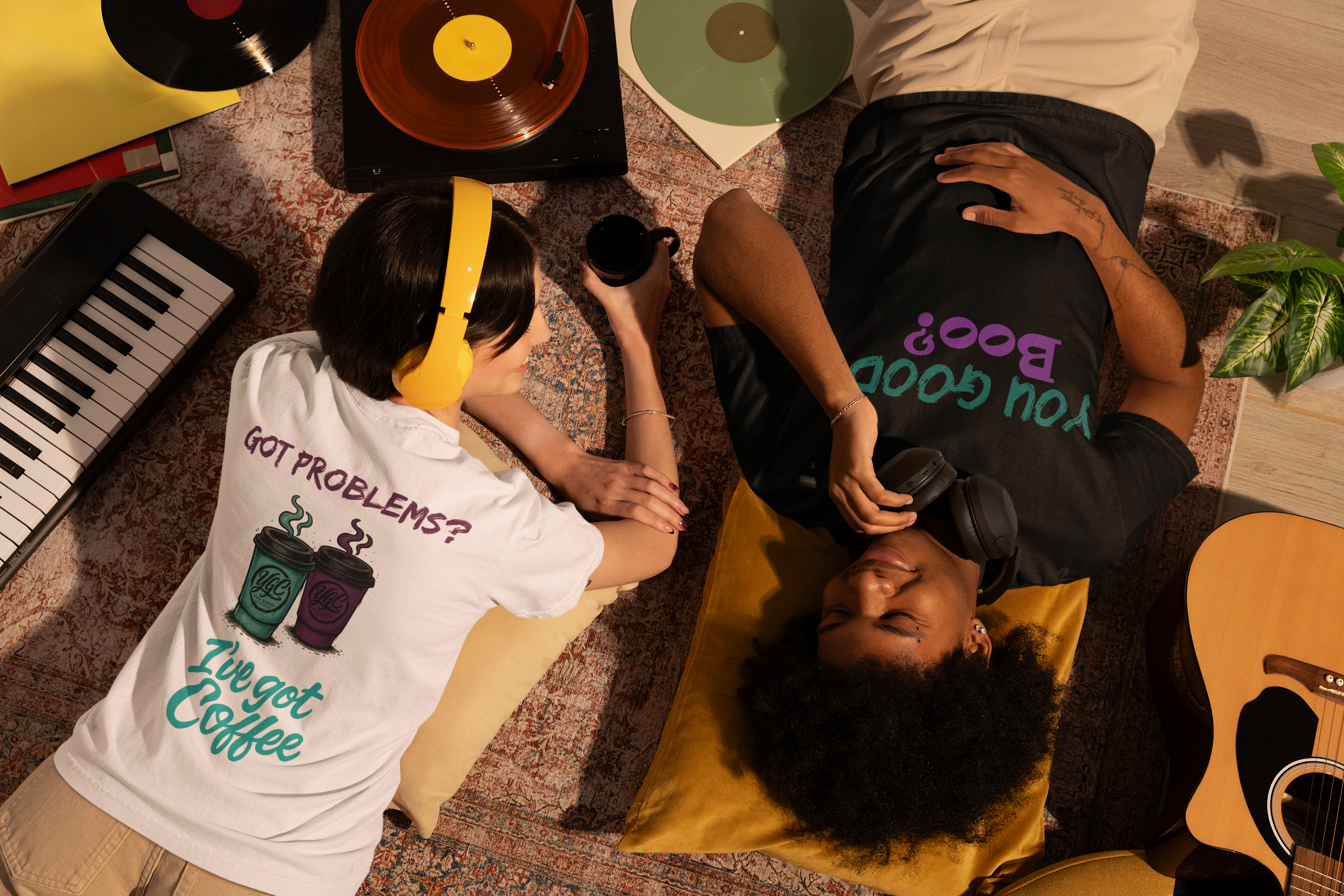 Two people sitting on a rug with vinyl records and a keyboard in the background